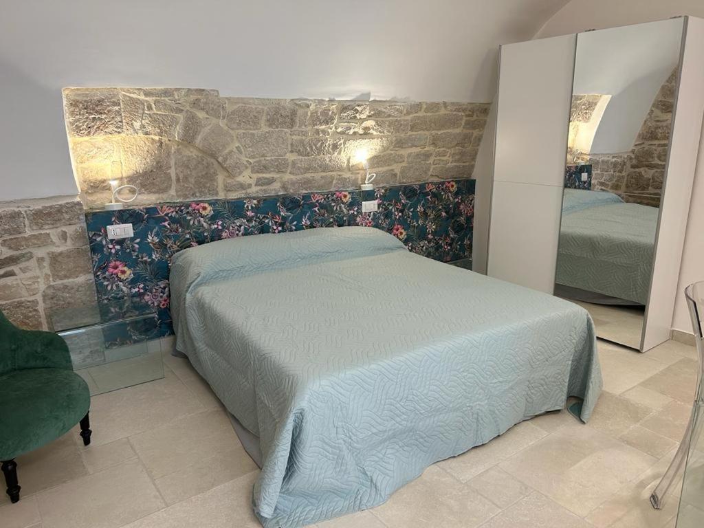 a bedroom with a bed and a mirror at Suite Duomo Trani 8 in Trani
