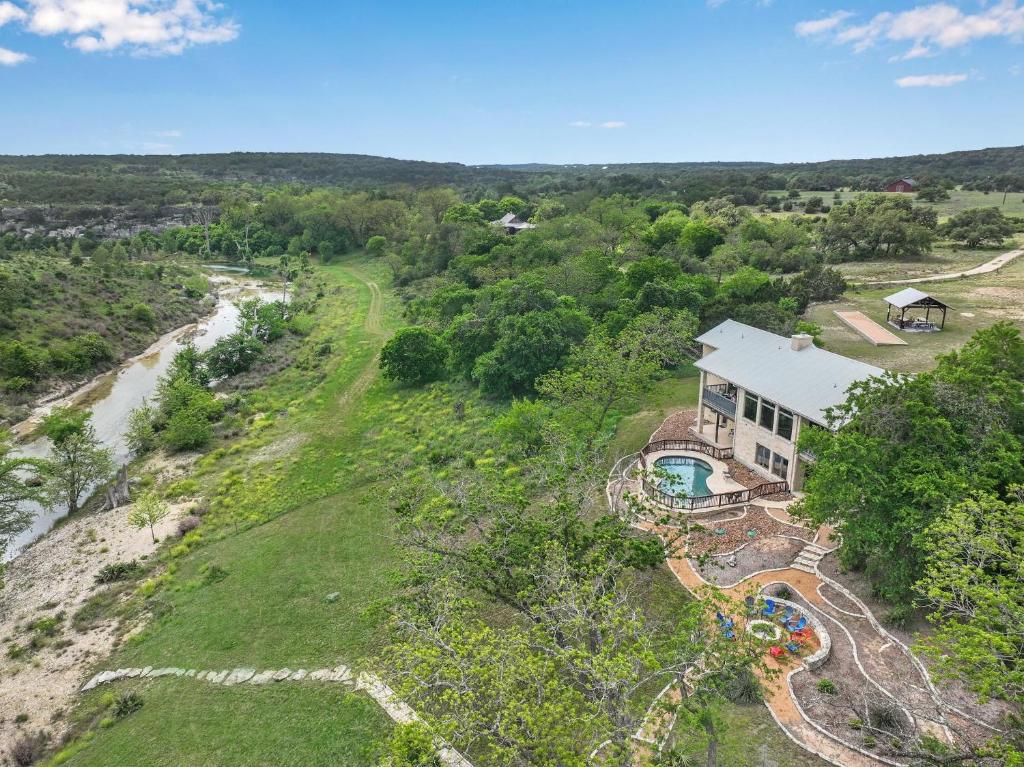 an aerial view of a house and a river at Rio Cantando in Wimberley