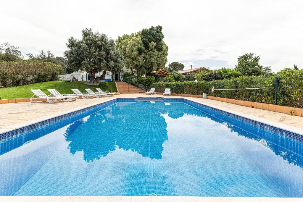 a swimming pool with blue water in a yard at Silves Retreat by Algarve Golden Properties in Silves