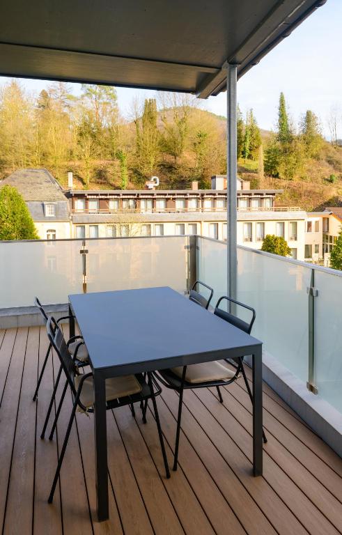 a blue table and chairs on a deck at Appart-Hotel Ernz Noire in Grundhof