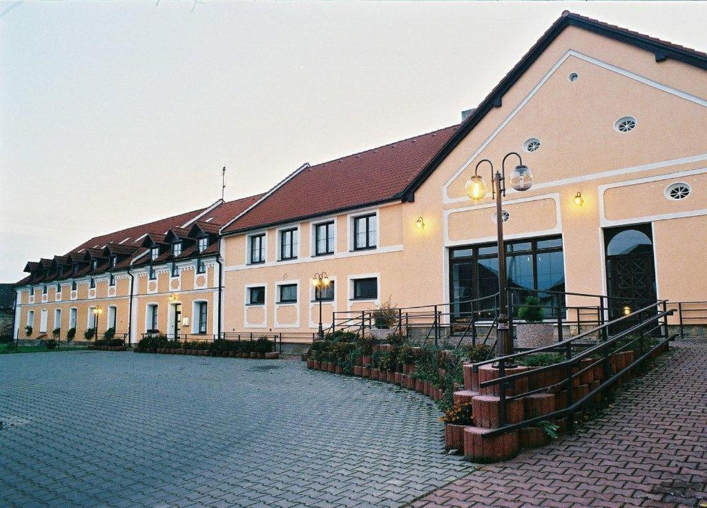 a large building with a cobblestone street in front of it at Pension u Svateho Jana in Hradec Králové