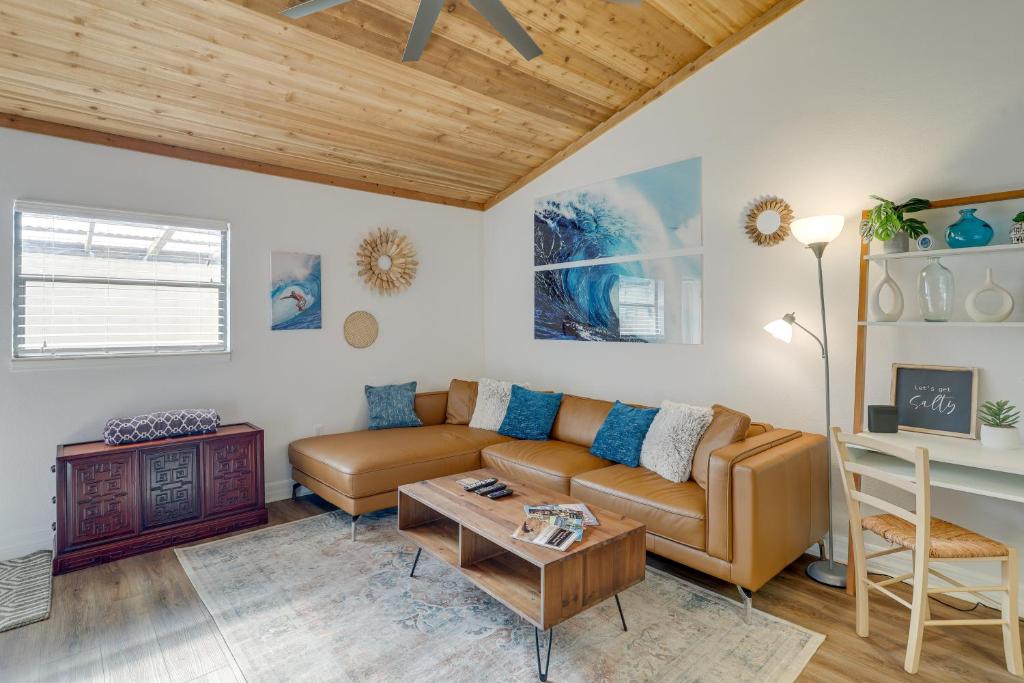 a living room with a couch and a table at Breezy Florida Retreat Near Beach and Port Canaveral in Cape Canaveral