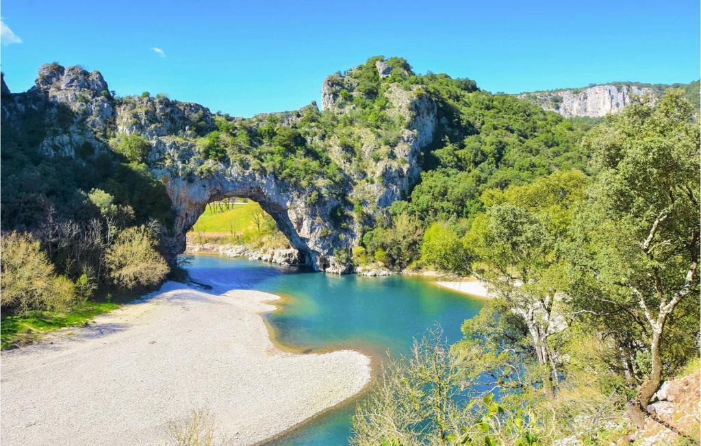 a view of a river with an arch in a canyon at Amazing Home In Lapalud With Outdoor Swimming Pool, Wifi And Private Swimming Pool in Lapalud