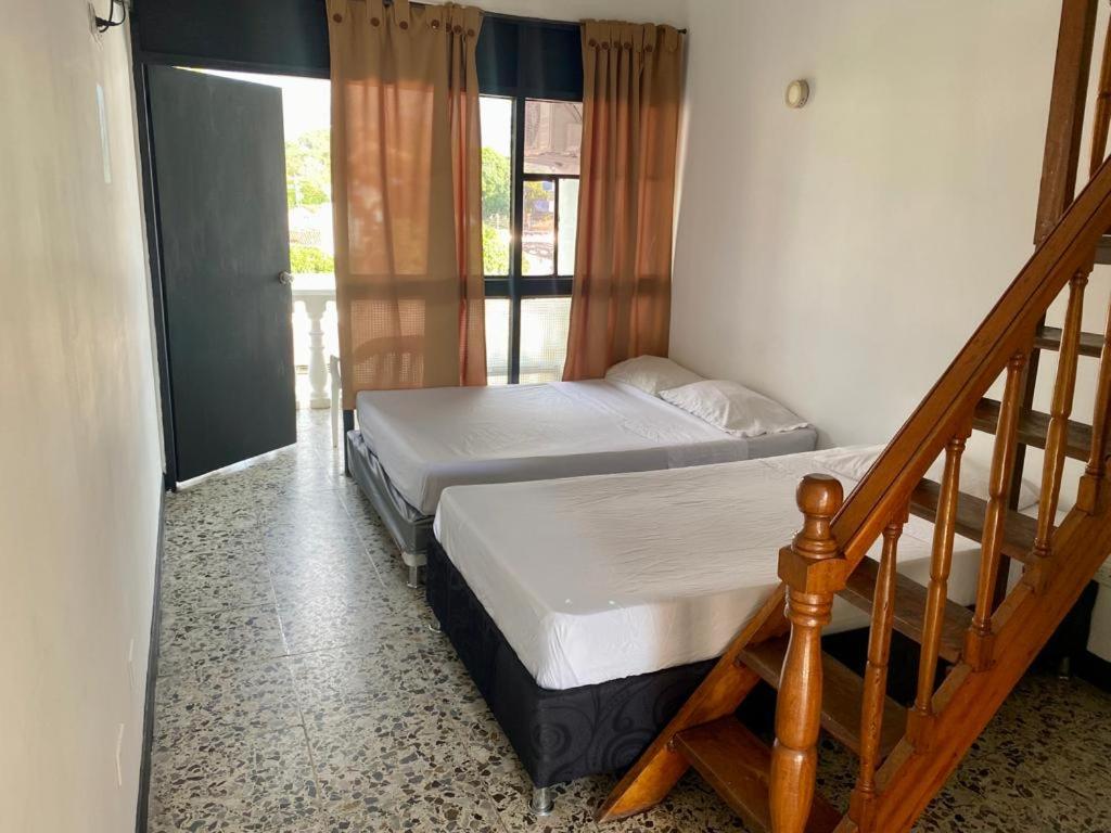 Postel nebo postele na pokoji v ubytování HOTEL MELGAR PLAZA