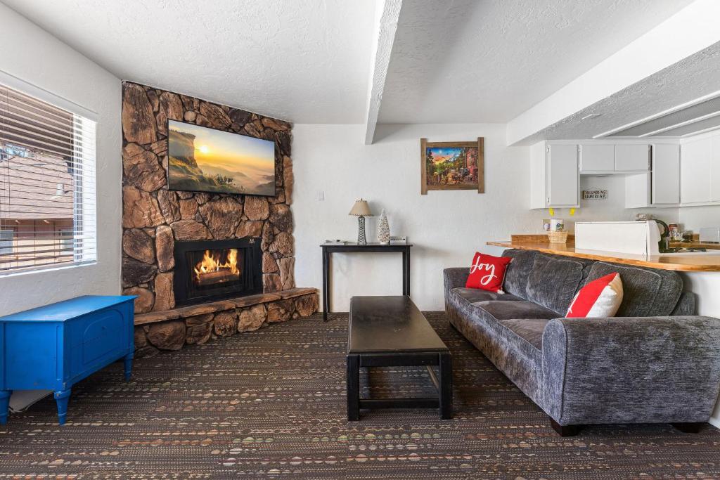 a living room with a couch and a fireplace at 04- Kodiak Bear At Village Suites Inn in Big Bear Lake