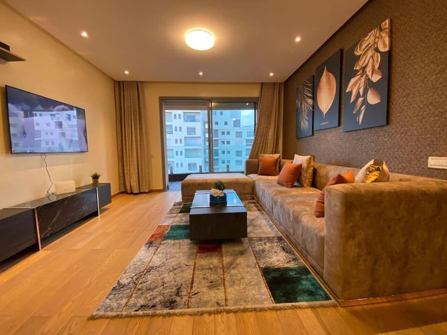 a living room with a couch and a tv at MARINA APARTMENT OCEAN VIEW in Casablanca