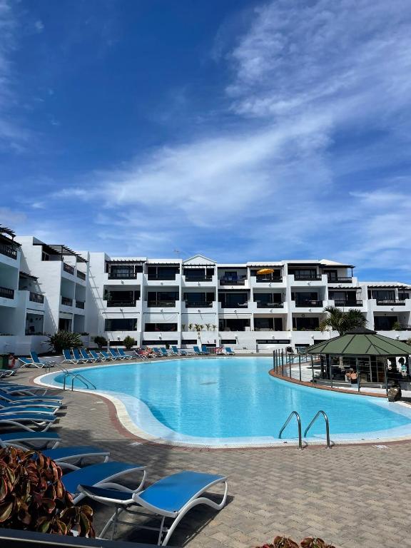 a large swimming pool in front of a hotel at Blue Ocean in Costa Teguise