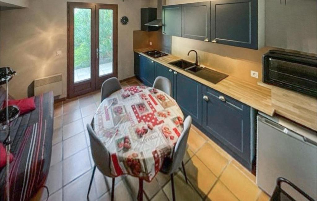 a kitchen with a table with a blanket on it at Amazing Home In Mazan With Wifi in Mazan