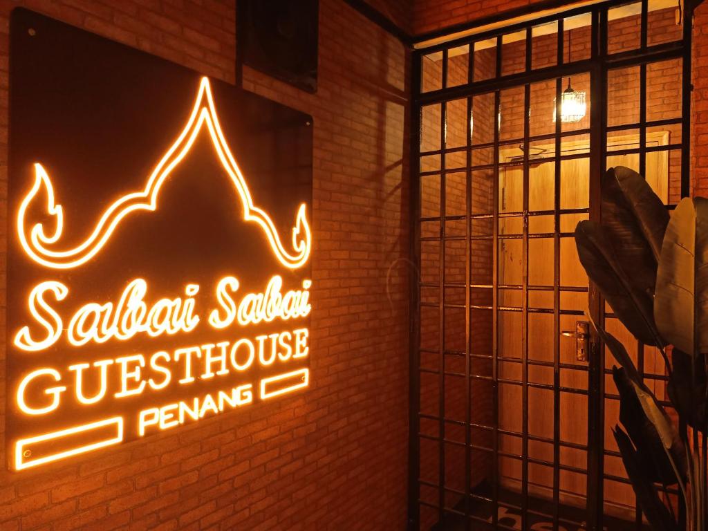 a neon sign on the wall of a restaurant at Cozy AC Shared Bunk Beds in Bayan Lepas in Bayan Lepas