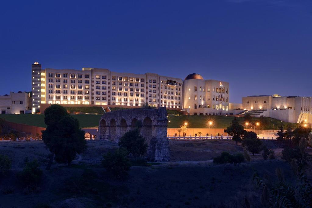 a large building in front of a building at night at Constantine Marriott Hotel in Constantine