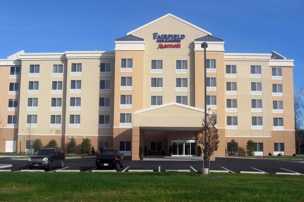 a hotel building with a sign on the front of it at Fairfield Inn & Suites Carlisle in Carlisle