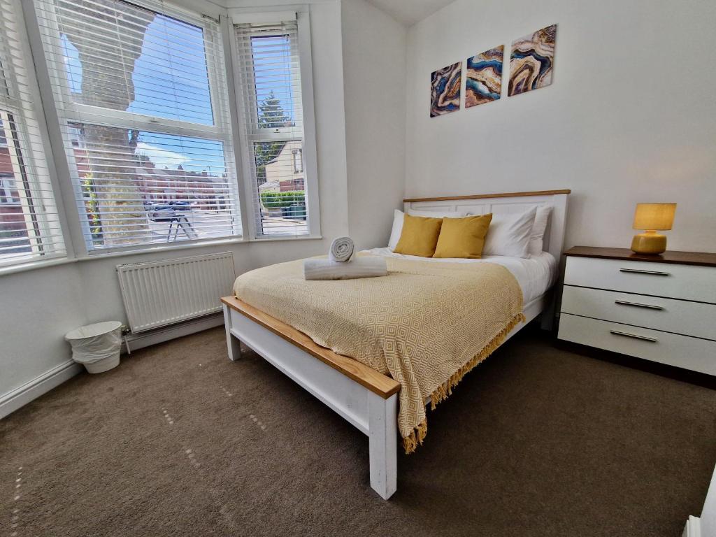 a bedroom with a bed and two windows at Incredible Private Rooms All with Private Bathrooms in a Fully Serviced House next to City Centre with Free Parking in Coventry