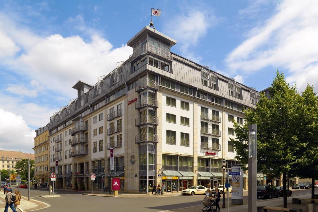 ライプツィヒにあるライプツィヒ マリオット ホテルの旗の立つ白い大きな建物