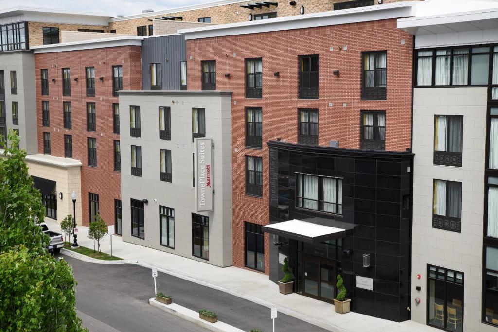 a rendering of a building with a black facade at TownePlace Suites by Marriott Lawrence Downtown in Lawrence