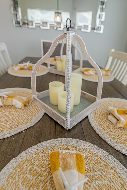a table with a tray with plates and dishes on it at Hot Tub - Ocean Views - Steps to Private Beach - Quiet Location in Galveston
