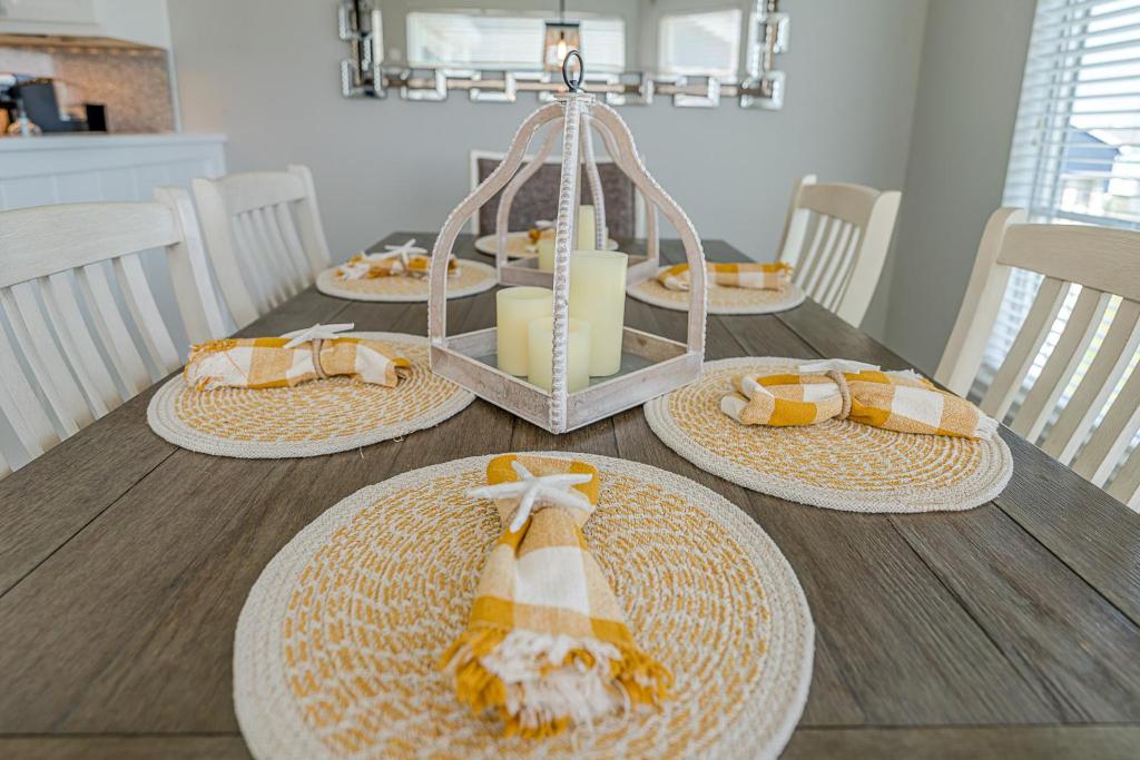 a wooden table with four straw hats on it at Hot Tub - Ocean Views - Steps to Private Beach - Quiet Location in Galveston
