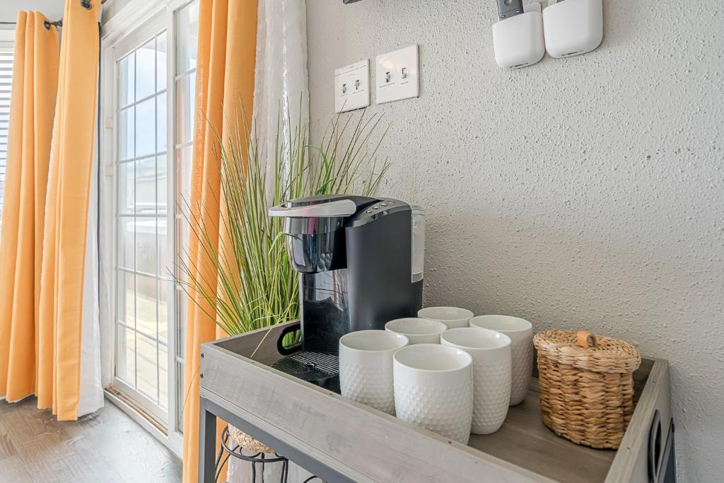 a coffee maker on a counter with cups on it at Hot Tub - Ocean Views - Steps to Private Beach - Quiet Location in Galveston