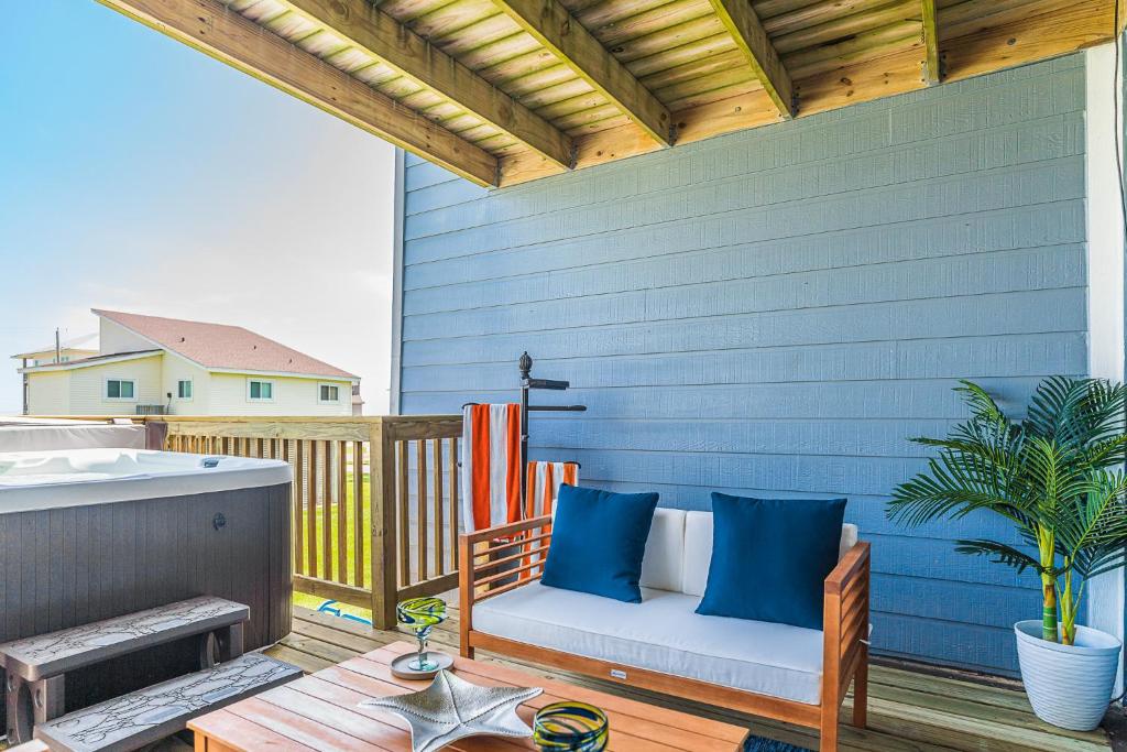 a patio with a bench on a wooden deck at Hot Tub - Ocean Views - Steps to Private Beach - Quiet Location in Galveston