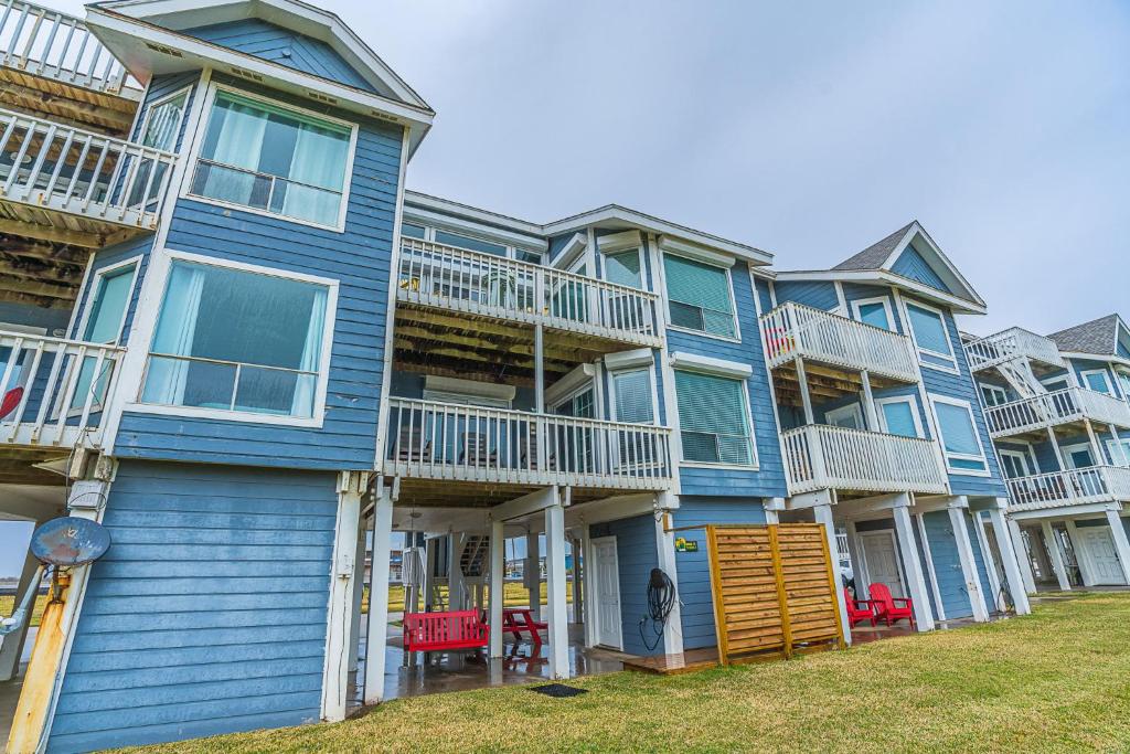 a row of blue condos with balconies at Hot Tub - Ocean Views - Steps to Private Beach - Quiet Location in Galveston