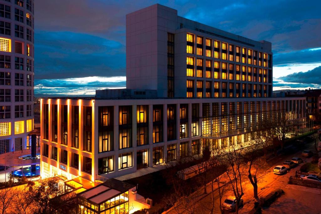 a building with lights on in a city at night at Lugal, A Luxury Collection Hotel in Ankara