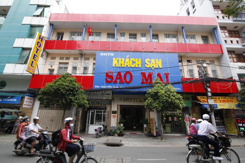 a group of people riding bikes down a street at KHÁCH SẠN SAO MAI in Ho Chi Minh City