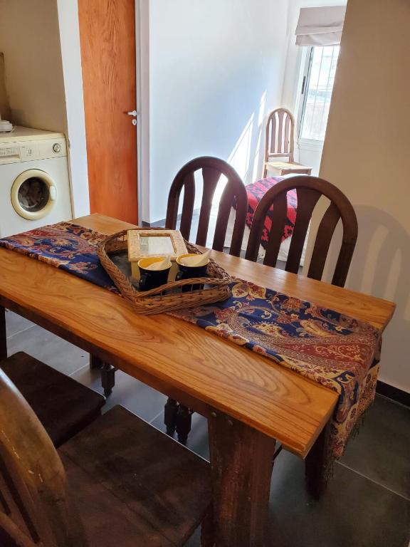 a wooden table with a basket of food on it at Alojamiento Concordia in Concordia