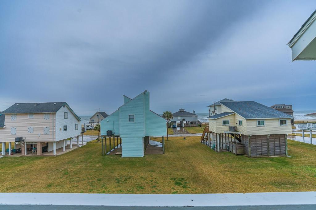 a group of houses and a playground in a yard at Hot Tub - Ocean Views - Steps to Private Beach - Quiet Location in Galveston