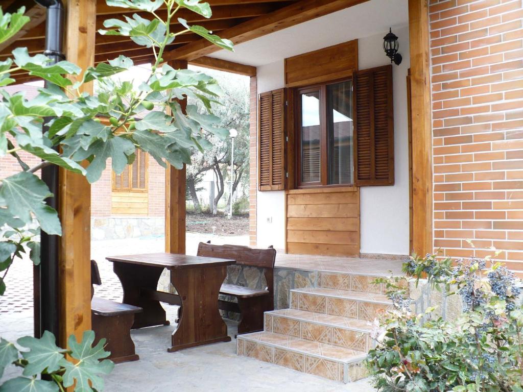 a porch with stairs and a table and a window at Villas and Bungalows Panorama in Chernomorets