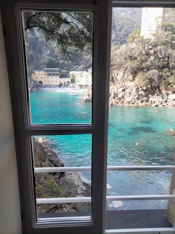 a window with a view of a body of water at Casa dell'Arco Civico 35 in San Fruttuoso