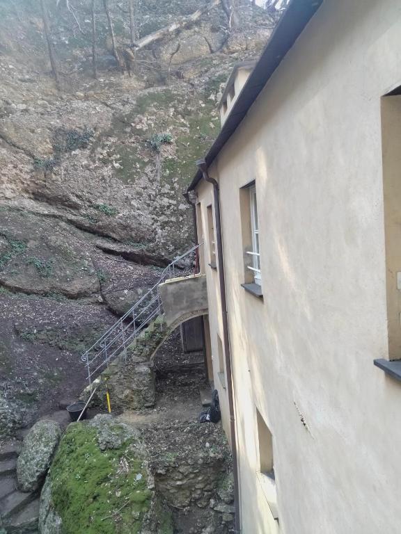a stairway leading to a building next to a mountain at Casa dell'Arco Civico 35 in San Fruttuoso