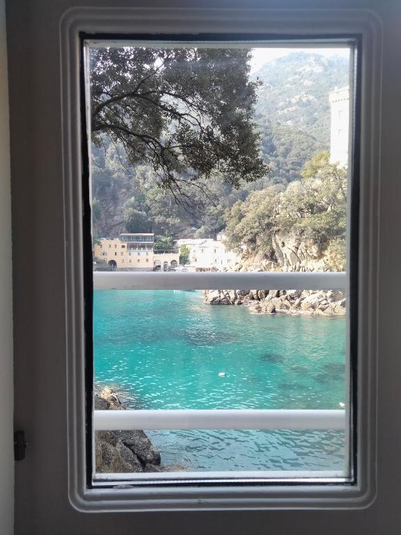 a window with a view of a body of water at Casa dell'Arco Civico 35 in San Fruttuoso