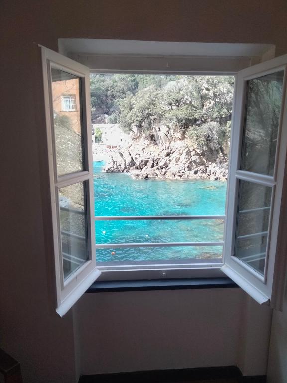 a window with a view of a body of water at Casa dell'Arco Civico 35 in San Fruttuoso