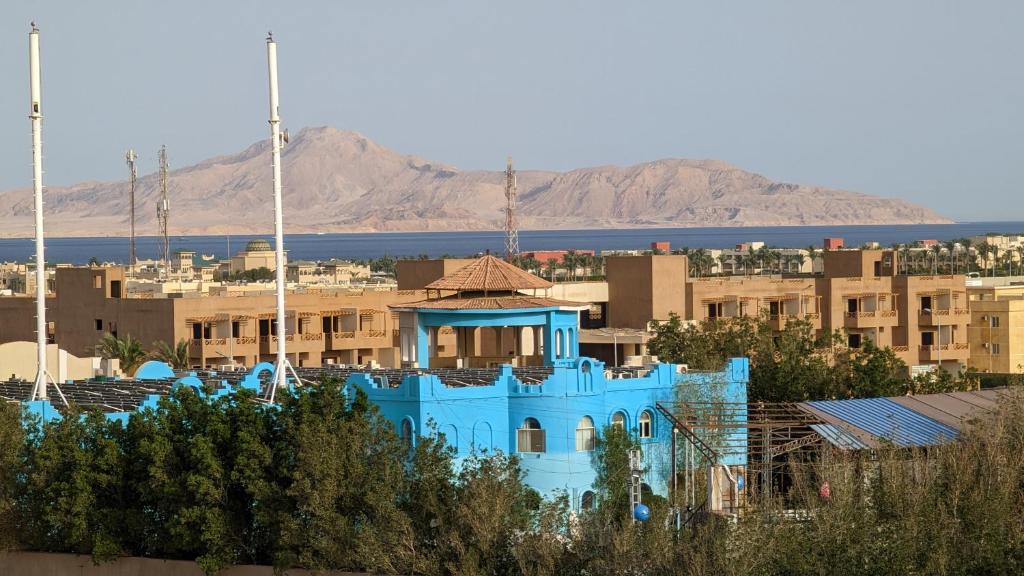 un bâtiment bleu au milieu d'une ville dans l'établissement Golf Heights Sea and Mountain View Studio with Free Wi-Fi, à Charm el-Cheikh