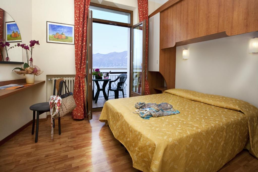 Postel nebo postele na pokoji v ubytování Hotel Merano