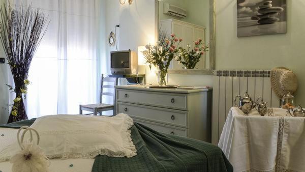 a bedroom with a bed and a dresser and a television at Terre del Sud in Locri