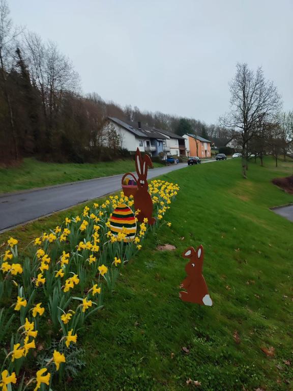two rabbits sitting in a field of daffodils at Die Ferienwohnungen Dominik , Fill in Horath