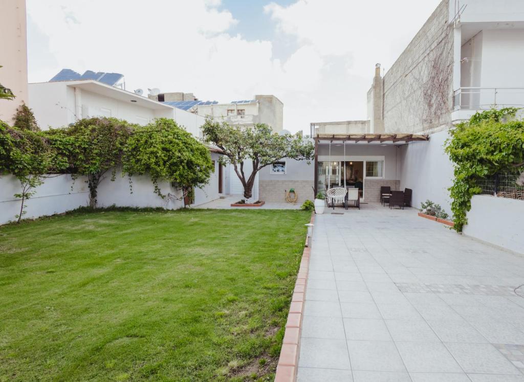 a courtyard in a house with a lawn at CITY CENTER VILLA HERSONISOS in Hersonissos