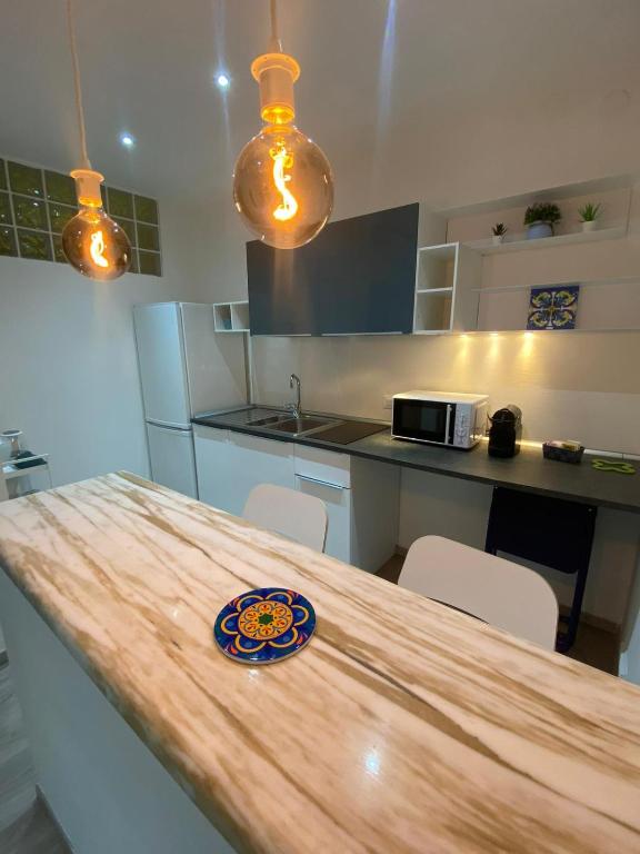 a kitchen with a wooden table with a plate on it at Suite Cinque terre Portovenere in La Spezia