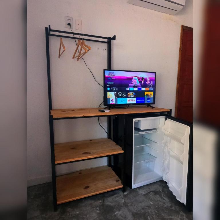 TV a/nebo společenská místnost v ubytování Pousada Siriba