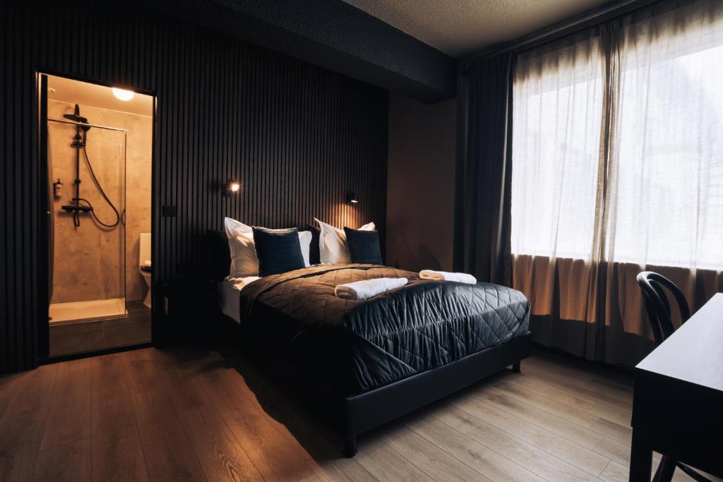 a black bedroom with a bed and a window at Brim Hotel in Reykjavík
