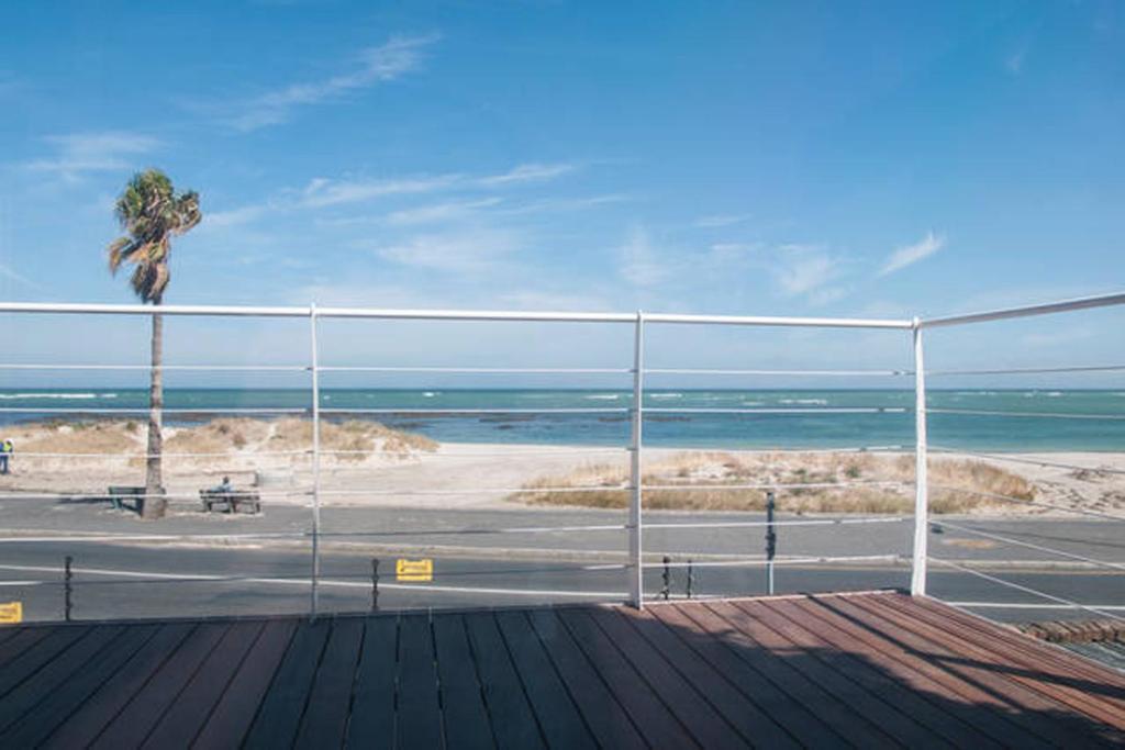 a view of the beach from a boardwalk at Afrique Somerset West in Strand