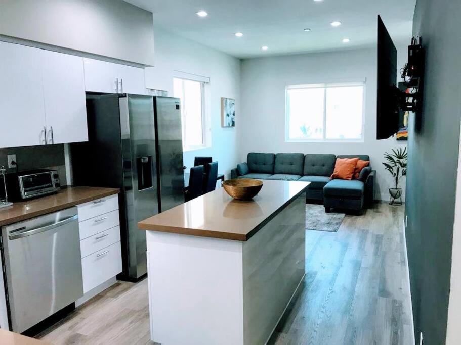a kitchen and living room with a couch at Spacious 4BR Townhouse in Mid City - WH-C2 in Los Angeles