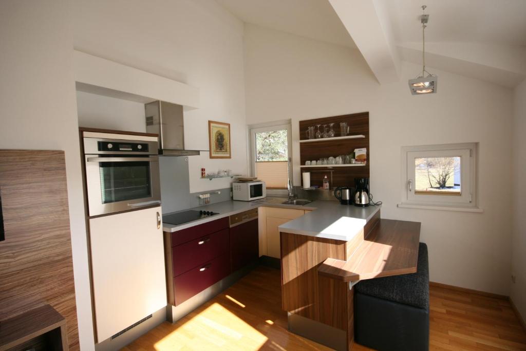 a kitchen with a white refrigerator and a counter at Appartements Zur Kapelle in Kaprun