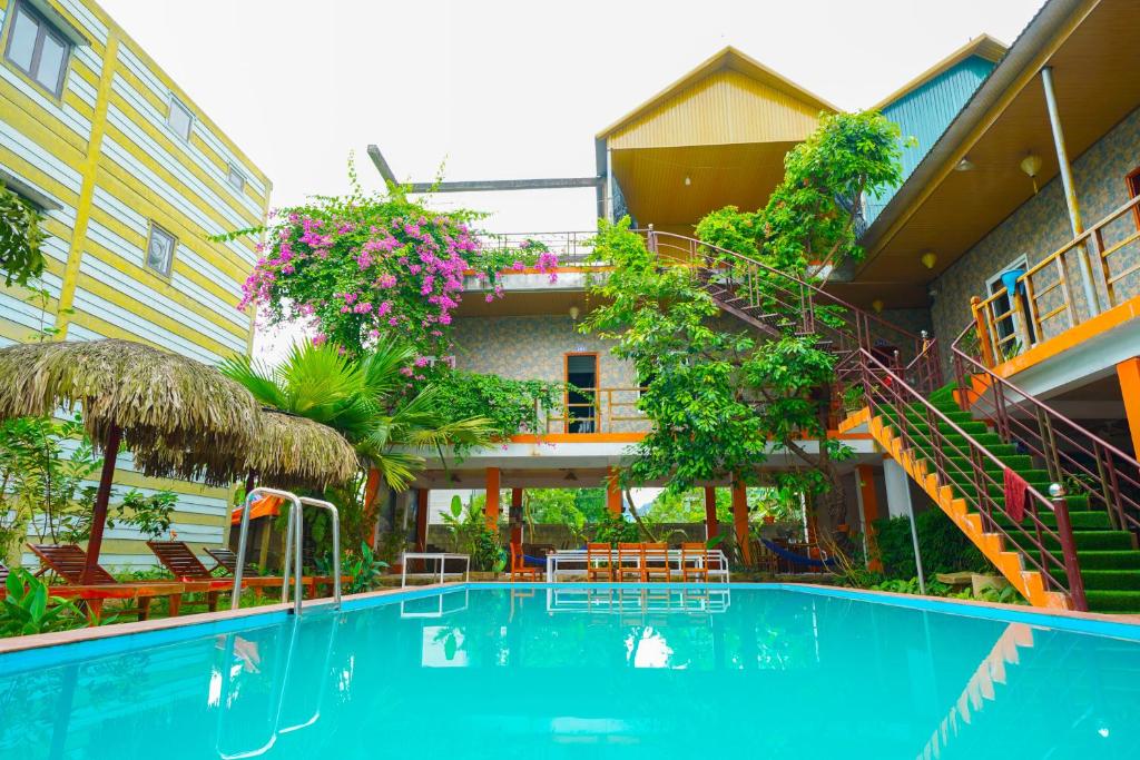 a swimming pool in front of a building at Phong Nha Dawn Home in Phong Nha