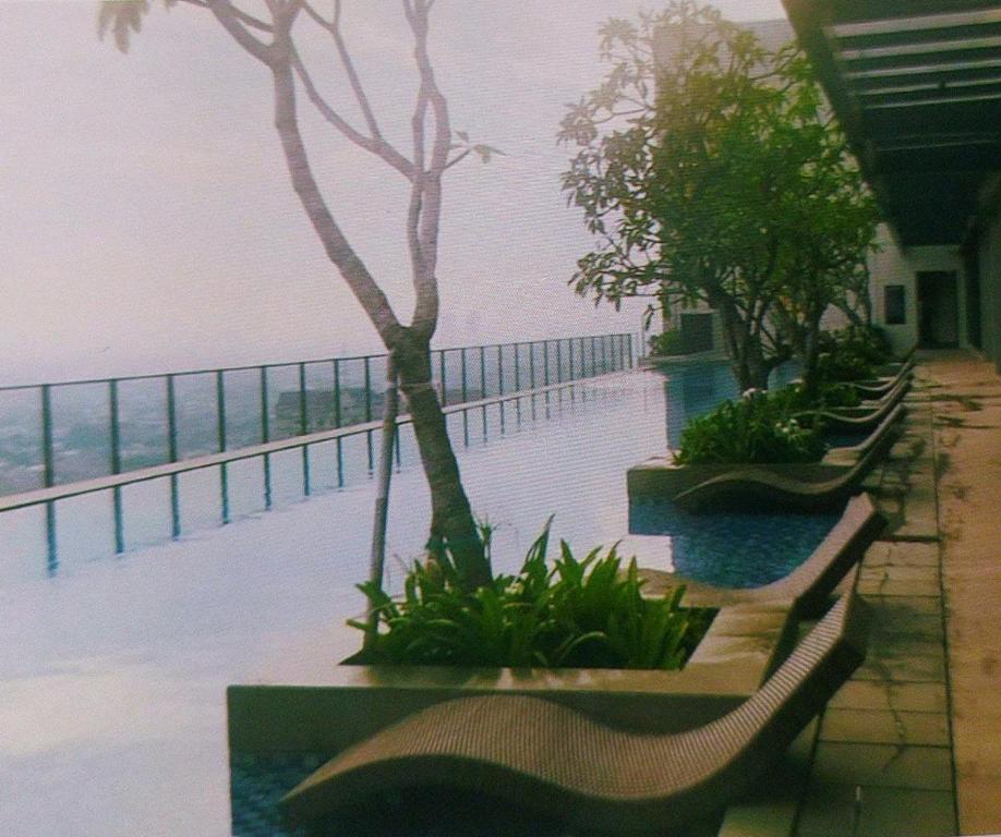 a row of benches on a building with a view of the ocean at Luxurious Apartement Lebak Bulus near MRT in Jakarta