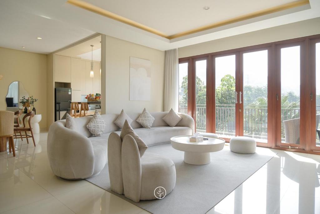 a living room with a couch and a table at Elok Villa 4 bedroom with a private pool in Bandung
