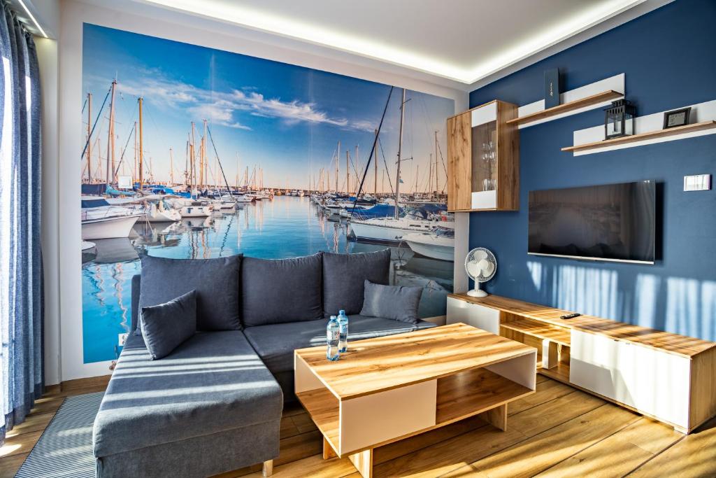 a living room with a view of a harbor at Apartament Yacht Park Marina in Gdynia