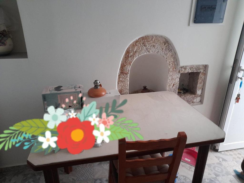 a dining room table with flowers on it at Erato Elafonisi in Agios Padeleimon