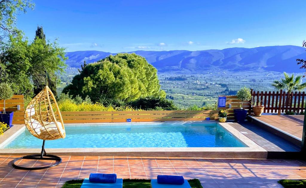 a swimming pool with a view of the mountains at Villa Pigi in Méson Yerakaríon