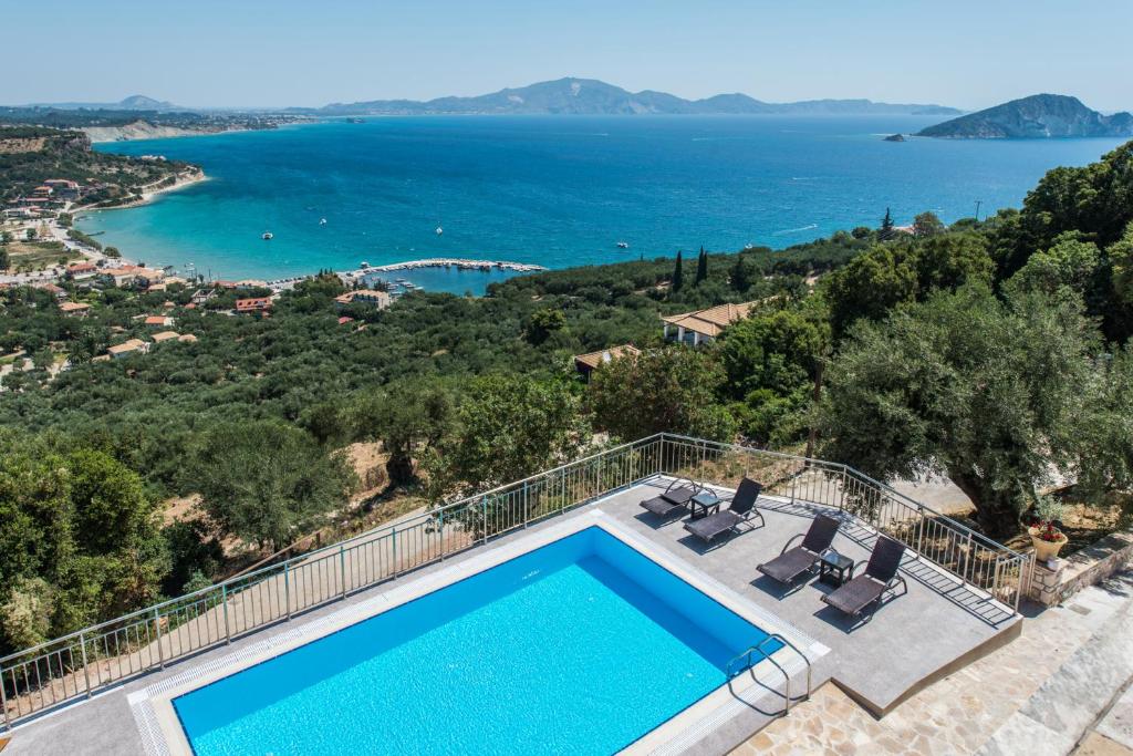 a villa with a swimming pool and a view of the ocean at Villa Eora in Keri